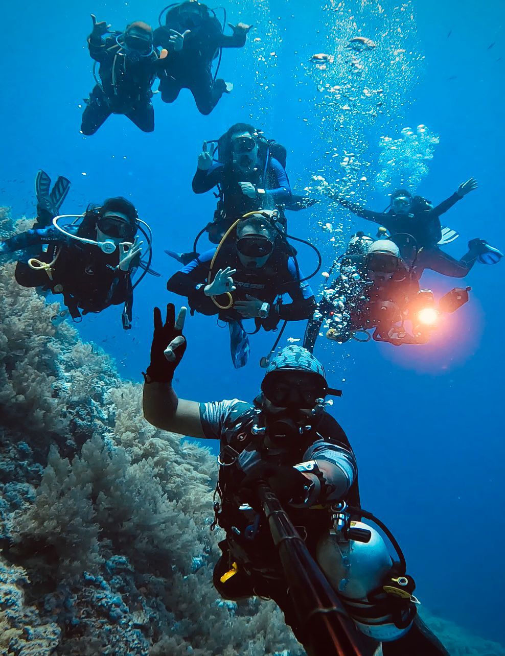 Group of open water divers practicing scuba skills during ocean dive