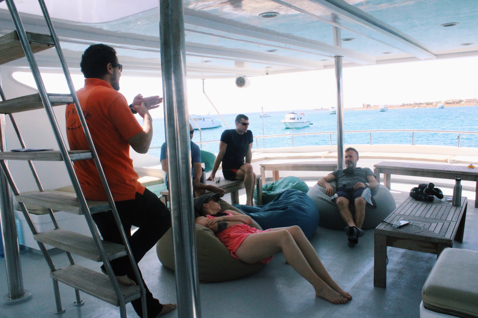 Guests relaxing on the sundeck of MY JP Marine between dives in the Red Sea
