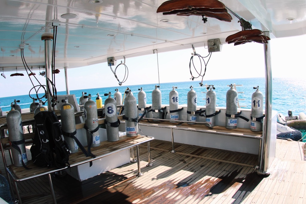 Diver preparing Nitrox equipment on the tank deck of MY JP Marine